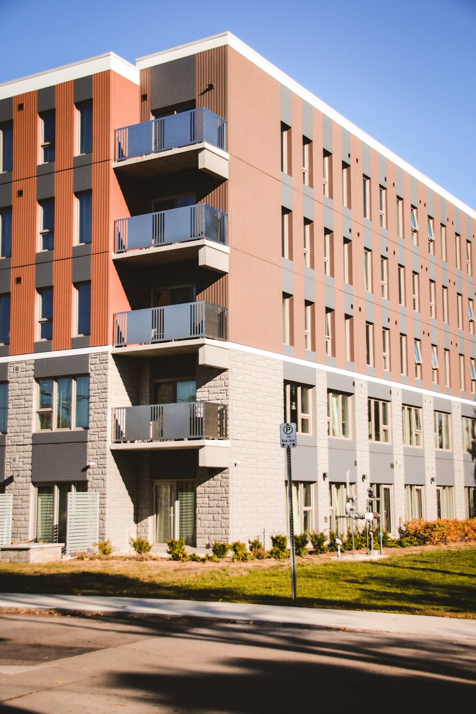 Modern apartment building with balconies on a sunny day.